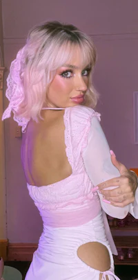 a woman in a white dress posing for a photo