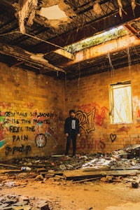 a man standing in an abandoned building