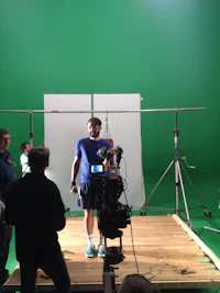 a man standing in front of a green screen