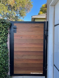 a wooden gate in front of a house