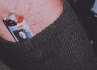 a picture of a man with a lighter on his thigh