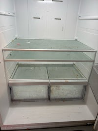 a refrigerator with a glass door that is open