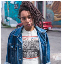 a woman with dreadlocks wearing a t - shirt