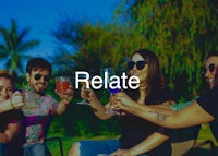 a group of people toasting to the word relate