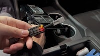 a person is holding a device in a car