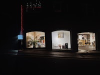 a shop window at night with lights on