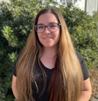 a young woman wearing glasses and a black shirt