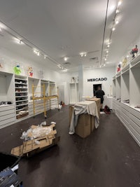 the inside of a store with shelves and boxes