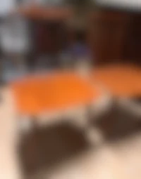 a pair of orange coffee tables in a room