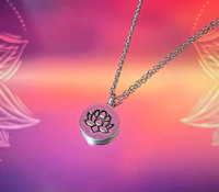 a silver necklace with a lotus flower on it