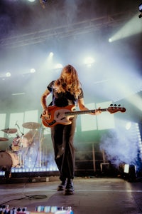 a man playing a guitar on stage at a concert