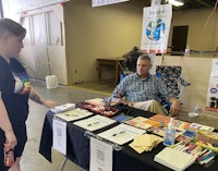a man talking to a girl at a table