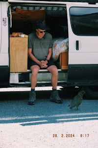 a man sitting in the back of a van