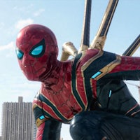 a spider - man is standing in front of a city