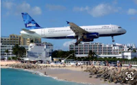 a jet airplane taking off from a beach