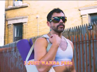 a man in sunglasses holding a yoga mat