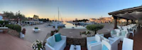 a 360 degree view of a marina with boats and tables