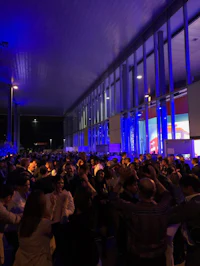 a crowd of people at a night event
