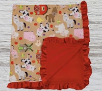 a baby blanket with farm animals and ruffled ruffles