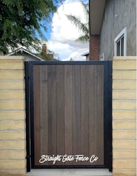 a wooden gate in front of a house