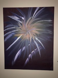 a painting of a firework on a wall