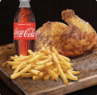 a chicken with fries and coca cola on a wooden cutting board