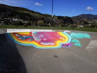 a skate park with a colorful mural painted on it