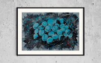 a framed print of blue grapes on a concrete wall