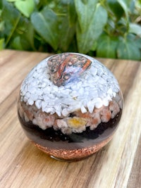 a small glass jar filled with sand and seashells
