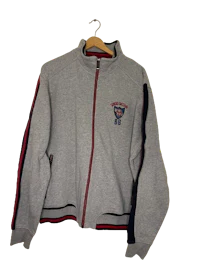 a grey sweatshirt with a red and blue logo on it