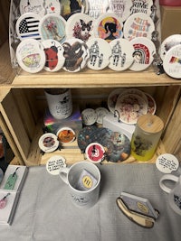 a crate with mugs and stickers on it