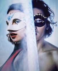 a man and woman in masks standing next to each other