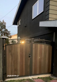 a wooden gate in front of a house
