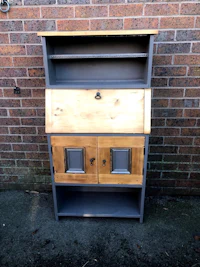 a wooden desk with drawers and a door
