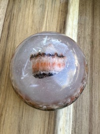 a piece of pink quartz sitting on top of a wooden table