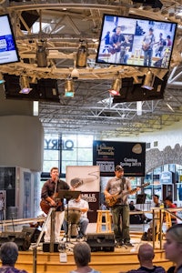 a group of people on stage in a shopping mall