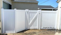a white vinyl fence in a backyard