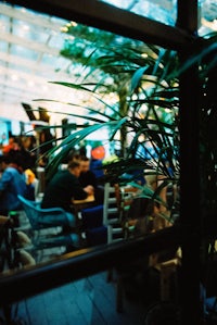 a group of people sitting at a table in a restaurant