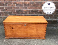 a wooden chest with a logo on it