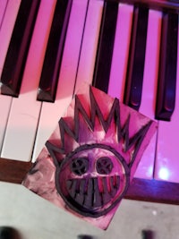 an image of a piano keyboard with a black and pink sticker on it
