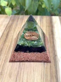 a glass pyramid with moss and ferns in it