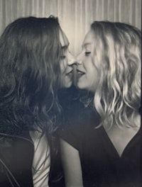 a black and white photo of two people kissing