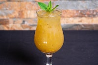 a drink with a mint leaf on top