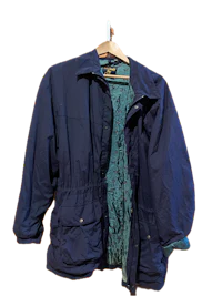a blue jacket hanging on a hanger