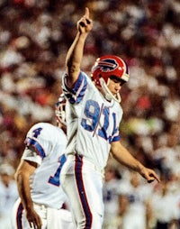 a football player raises his fist in the air