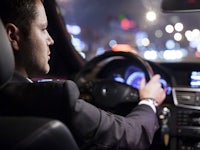 a man driving a car at night