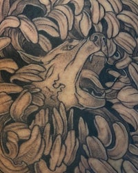 a black and grey tattoo of a wolf with bananas