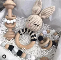 a wooden box with a crocheted bunny in it