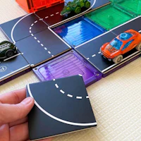 a person is playing with a toy car game