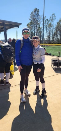 two softball players posing for a picture